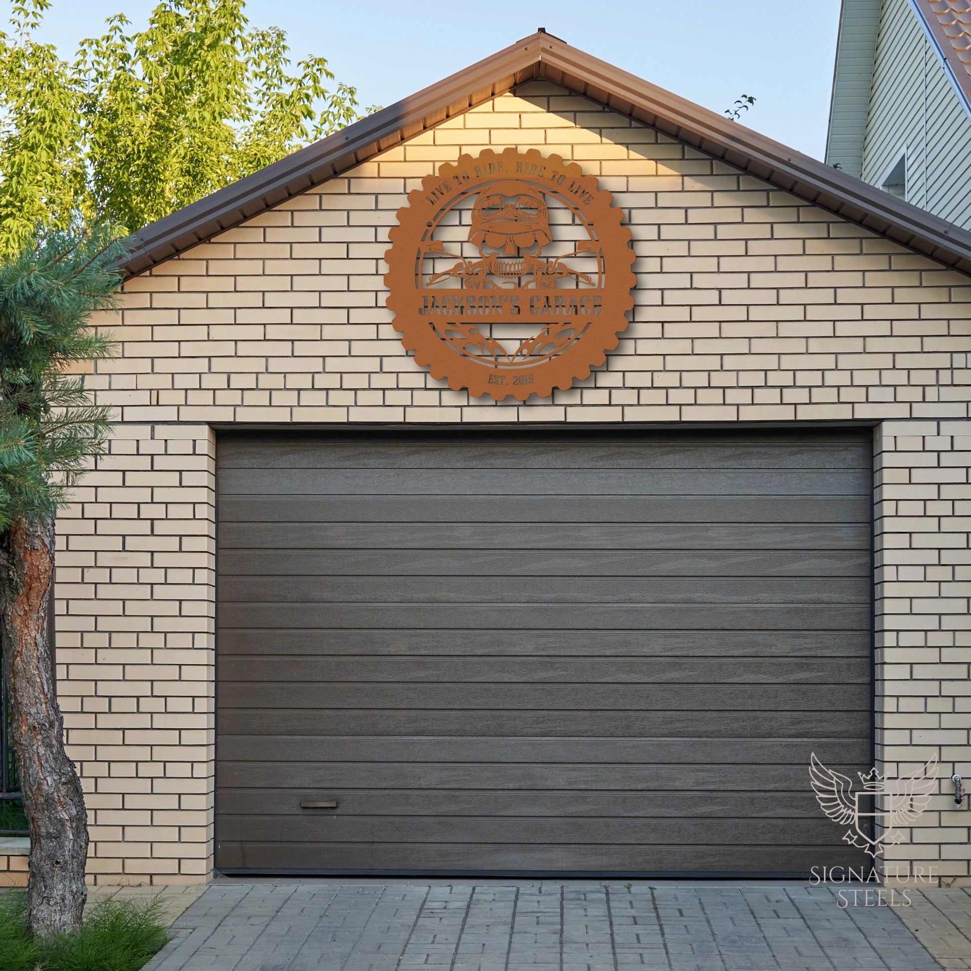 A metal sign with a skull and flames hanging above the garage door.