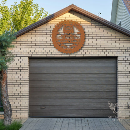 A metal sign with a skull and flames hanging above the garage door.