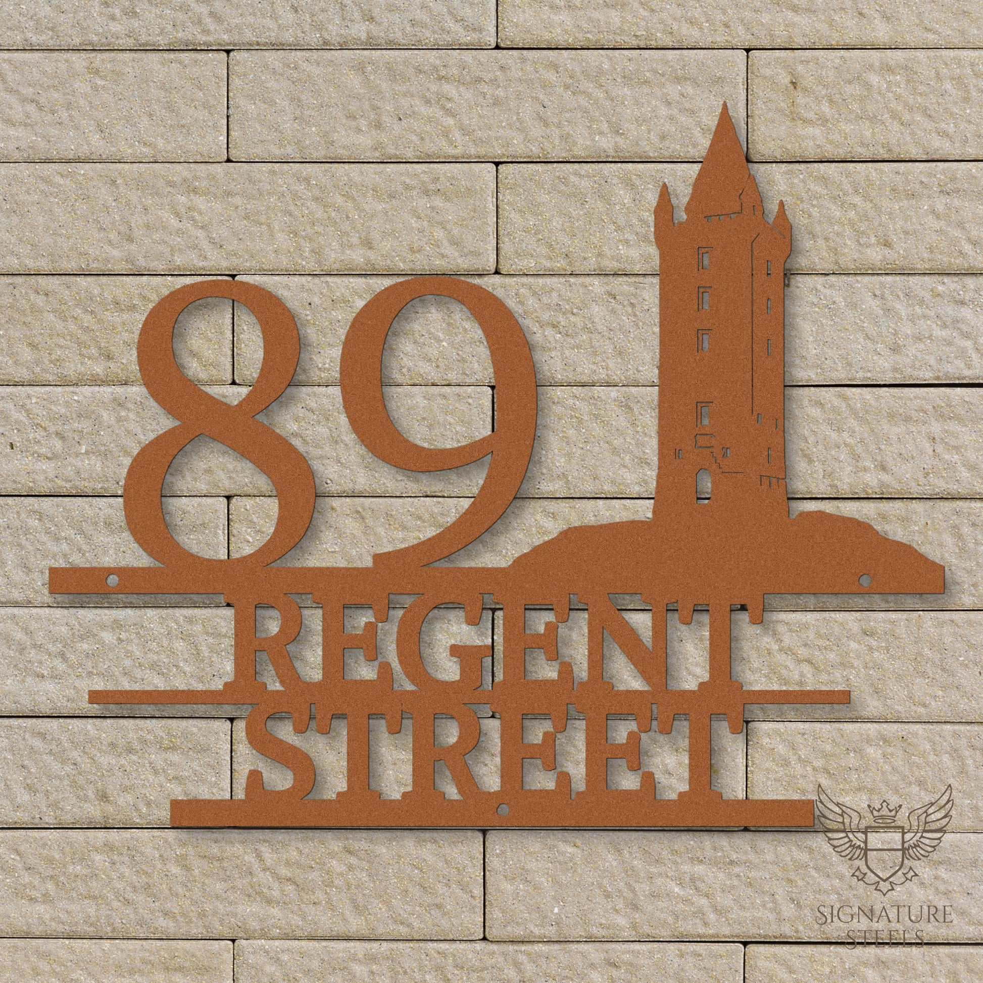 Copper metal address sign with house number 89, street name Regent Street, horizontal parallel lines and a silhouette of Scrabo Tower, a landmark of Newtownards in Northern Ireland, hanging on a beige brick wall.